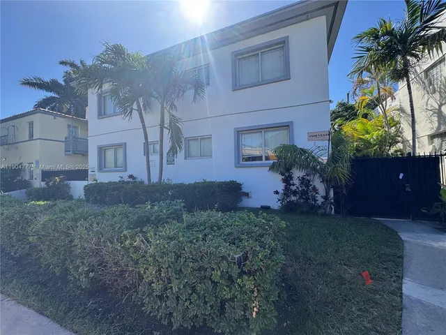 a house that has a tree in front of it