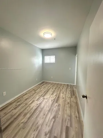 a view of an empty room and a window