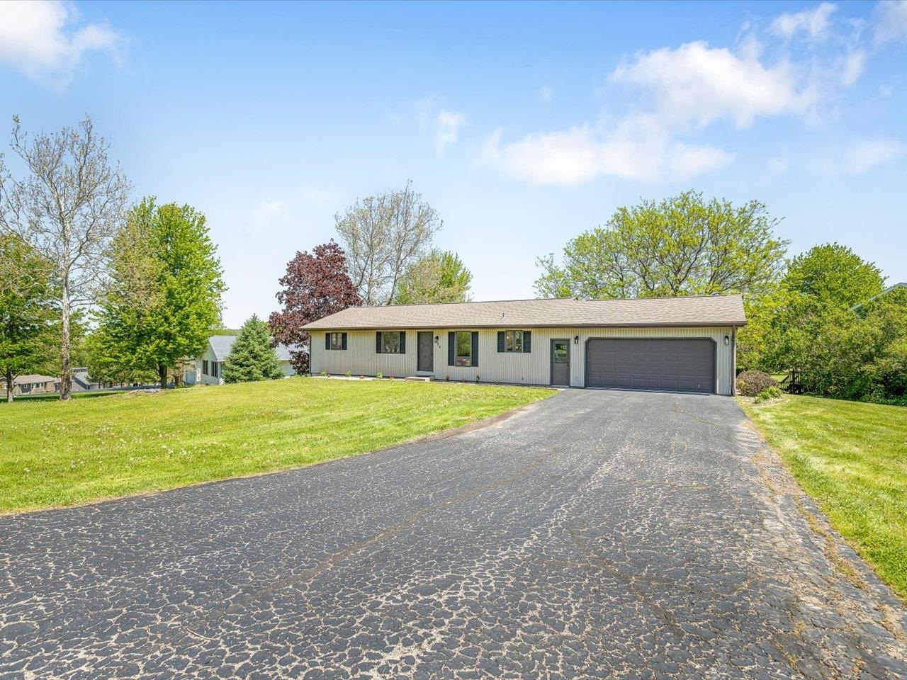 136 Lake Summerset Road Lake Summerset, IL 61019 - Photo 43 of 47 a front view of house with yard and trees in the background