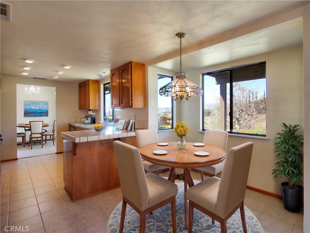 36116 Sharon Way Yucaipa, CA 92399 - Photo 13 of 34 a dining room with furniture a chandelier and wooden floor