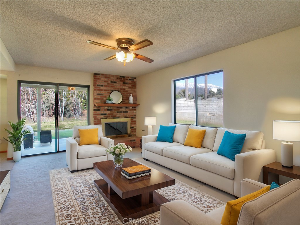 36116 Sharon Way Yucaipa, CA 92399 - Photo 14 of 34 a living room with furniture ceiling fan and a large window