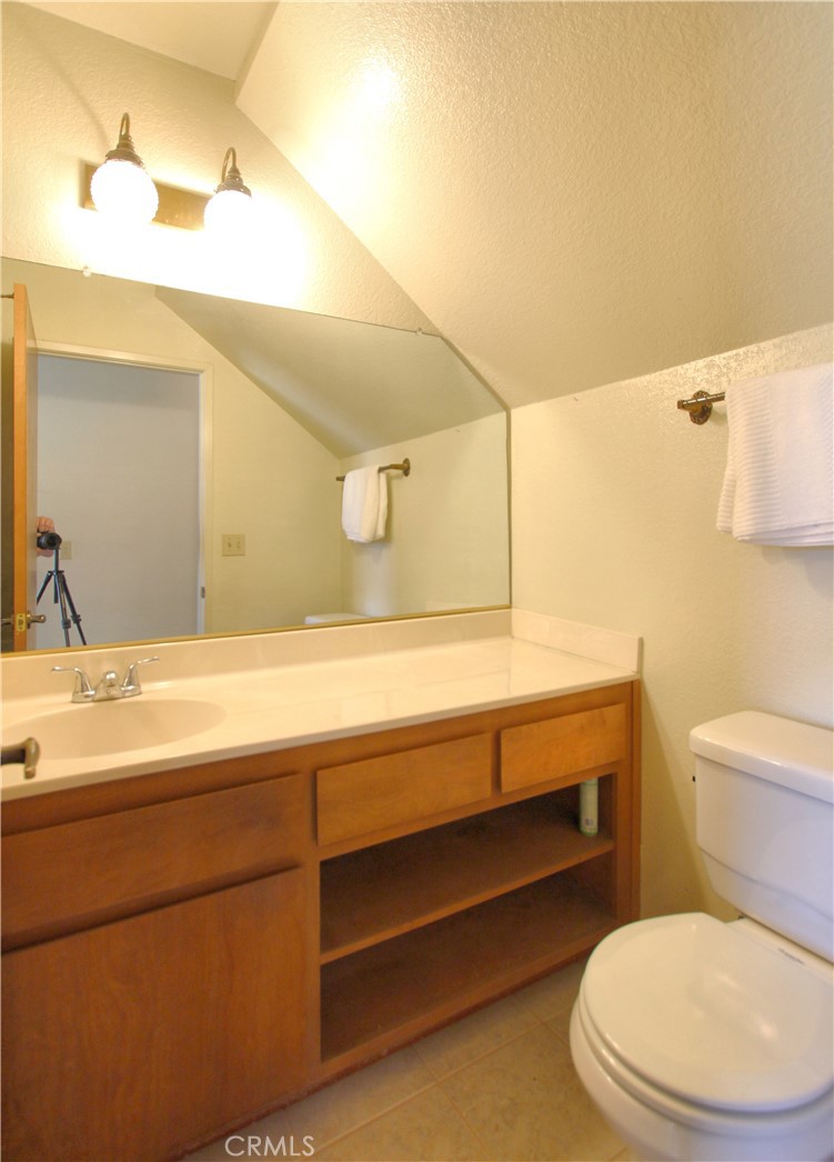 36116 Sharon Way Yucaipa, CA 92399 - Photo 15 of 34 a bathroom with a toilet a sink and mirror