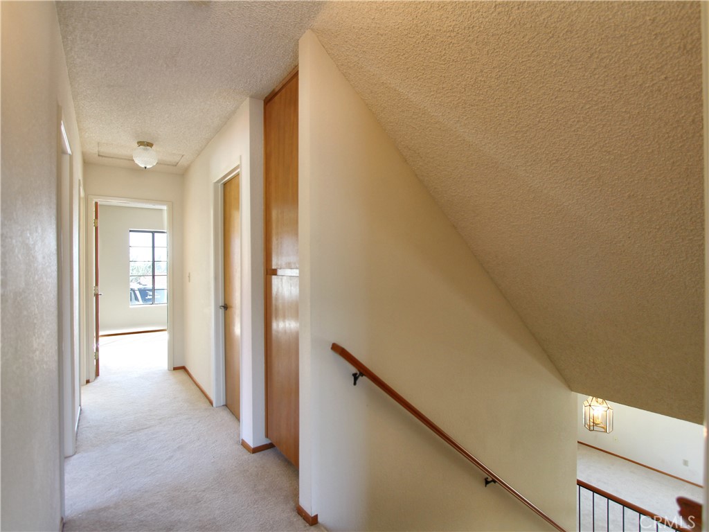 36116 Sharon Way Yucaipa, CA 92399 - Photo 17 of 34 a view of a hallway with wooden shelves