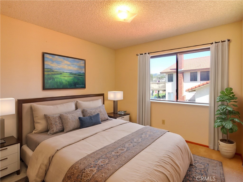 36116 Sharon Way Yucaipa, CA 92399 - Photo 19 of 34 a bedroom with a bed and a window