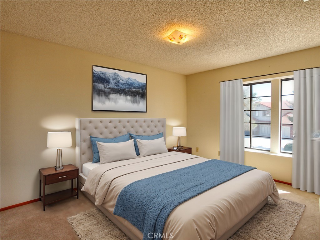 36116 Sharon Way Yucaipa, CA 92399 - Photo 20 of 34 a bedroom with bed and a night stand