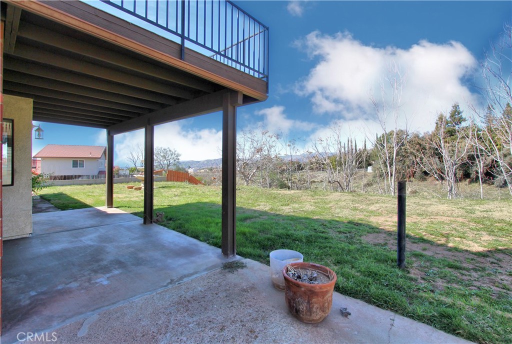 36116 Sharon Way Yucaipa, CA 92399 - Photo 29 of 34 a view of a patio with a table chairs and a yard