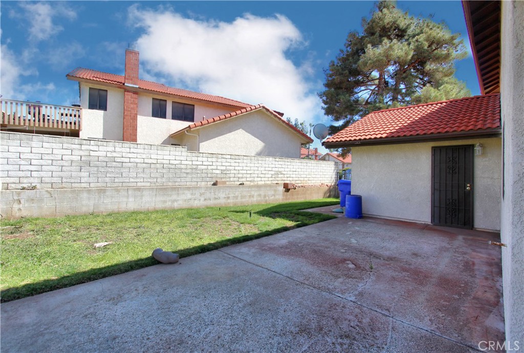 36116 Sharon Way Yucaipa, CA 92399 - Photo 30 of 34 a view of a house with a yard and garage