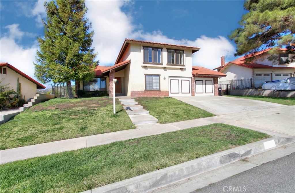 36116 Sharon Way Yucaipa, CA 92399 - Photo 3 of 34 a front view of a house with a yard and trees