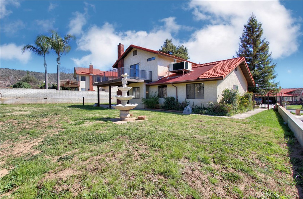 36116 Sharon Way Yucaipa, CA 92399 - Photo 33 of 34 a front view of a house with a yard and palm trees