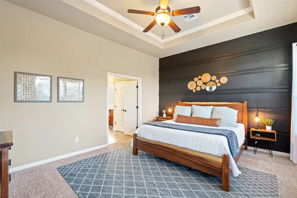 a bedroom with a bed and a chandelier