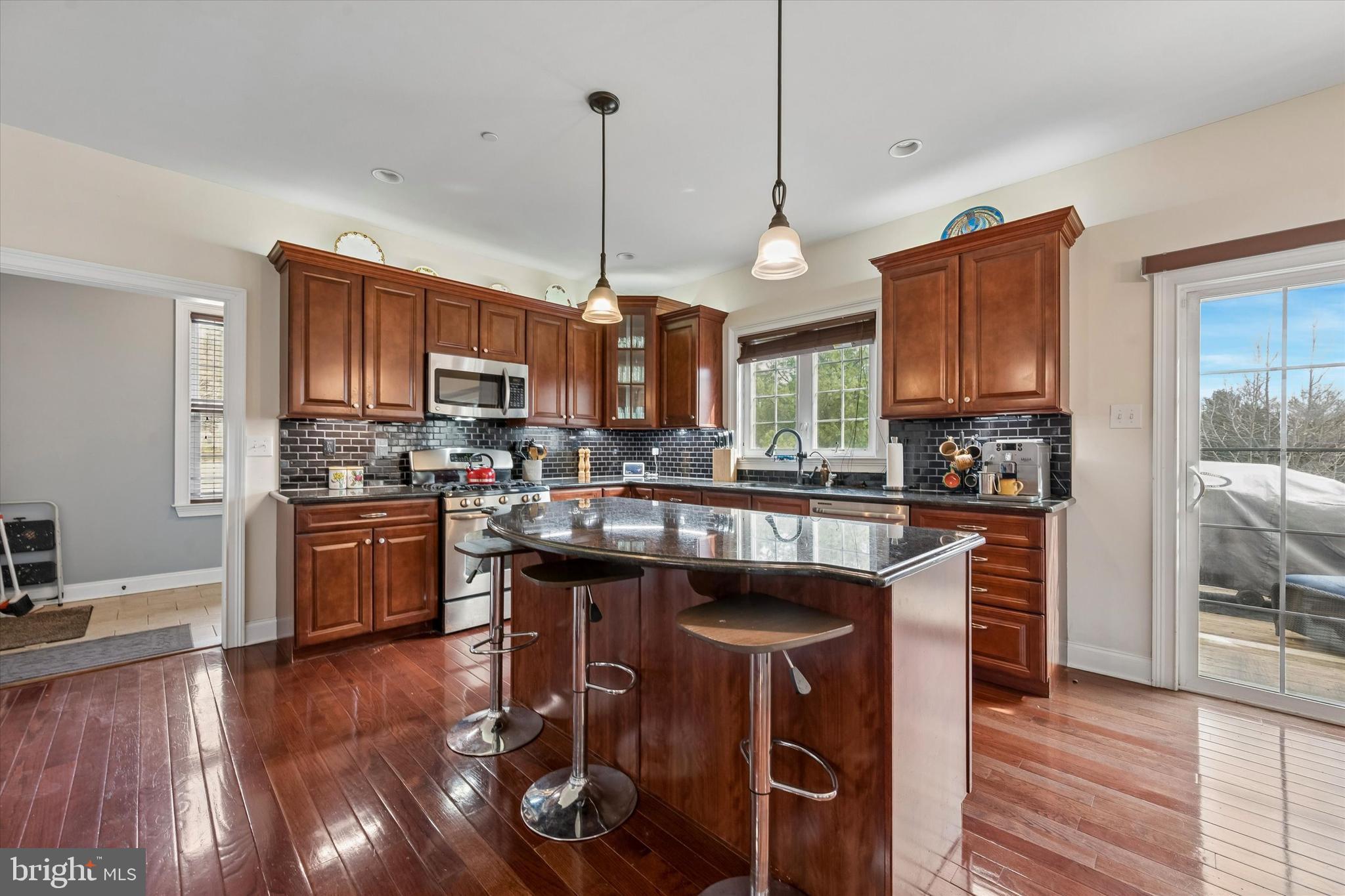 301 Jennifer Lane Exton, PA 19341 - Photo 11 of 41 a kitchen with stainless steel appliances granite countertop wooden floors a stove and a refrigerator