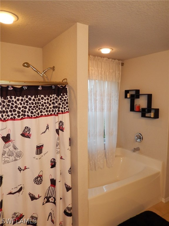 425 Jourferie Road Lehigh Acres, FL 33974 - Photo 17 of 25 a bathroom with a bathtub and a shower