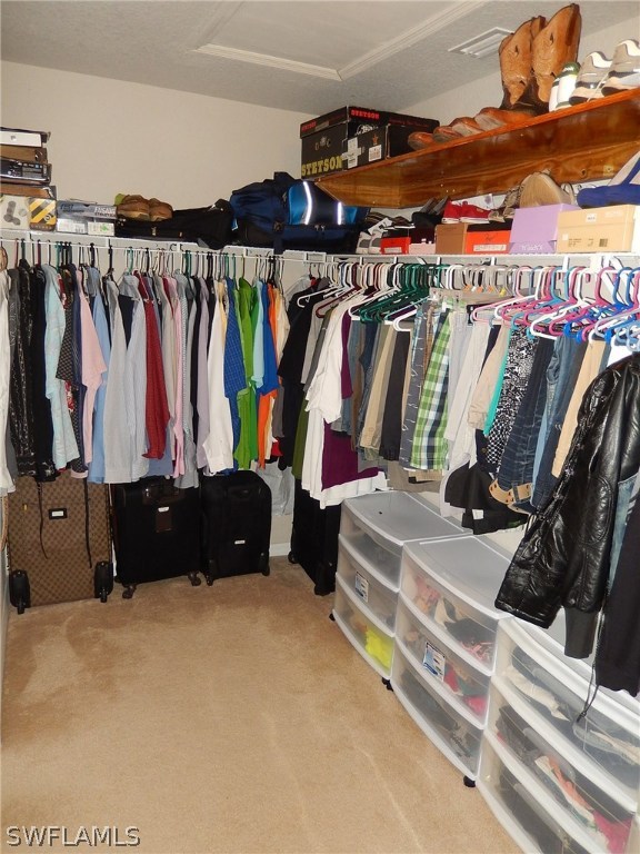 425 Jourferie Road Lehigh Acres, FL 33974 - Photo 18 of 25 a view of walk in closet with clothes and shoes