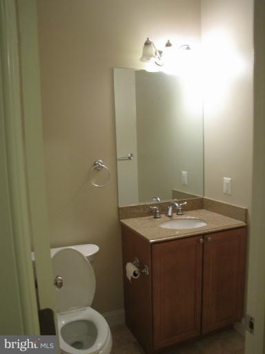 1740 18th Street Northwest, Unit 104 Washington, DC 20009 - Photo 5 of 13 a bathroom with a granite countertop sink toilet and mirror