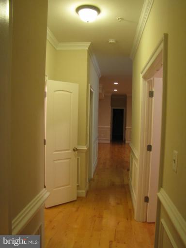 1740 18th Street Northwest, Unit 104 Washington, DC 20009 - Photo 10 of 13 a view of a hallway with wooden shelves