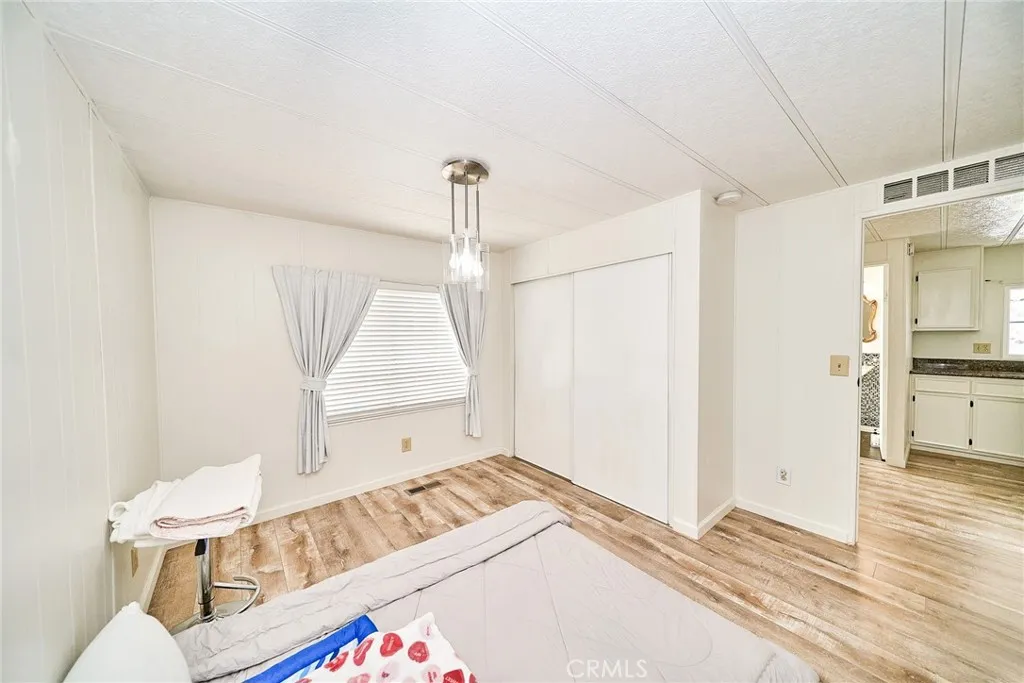 4000 Pierce Street, Unit 168 Riverside, CA 92505 - Photo 16 of 34 a view of an empty room and wooden floor