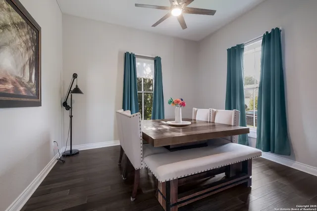 a dining room with furniture and wooden floor
