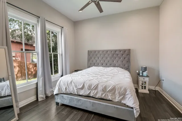 a bedroom with a bed and wooden floor