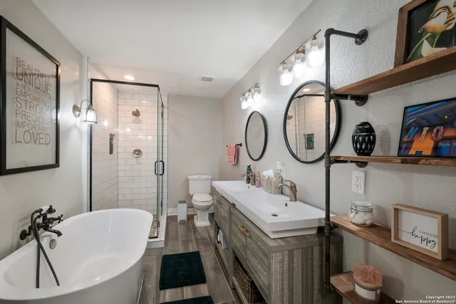 a bathroom with a sink a toilet and a mirror