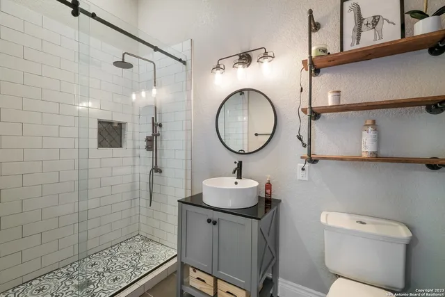 a bathroom with a sink toilet and shower