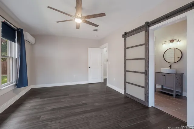 a view of a room with wooden floor and white walls