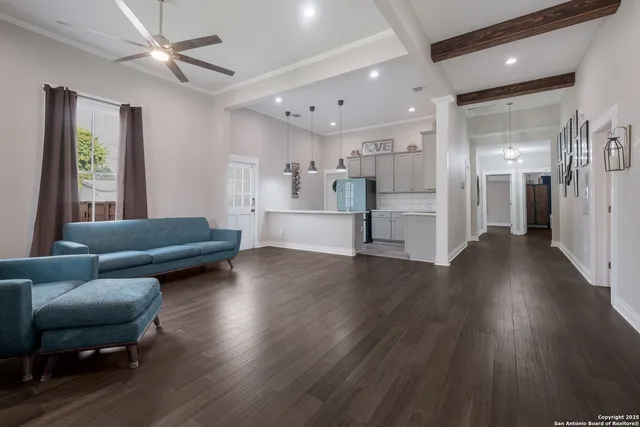 a living room with furniture and a wooden floor