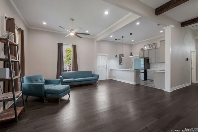 a view of a livingroom with furniture and a kitchen