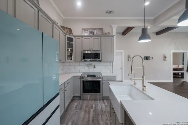 a kitchen with stainless steel appliances a stove sink and microwave