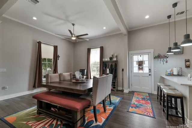 a dining room with wooden floor and window