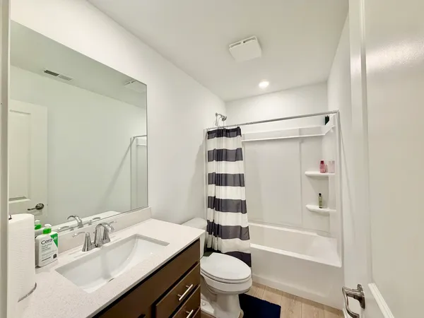 a bathroom with a sink double vanity granite tub and shower