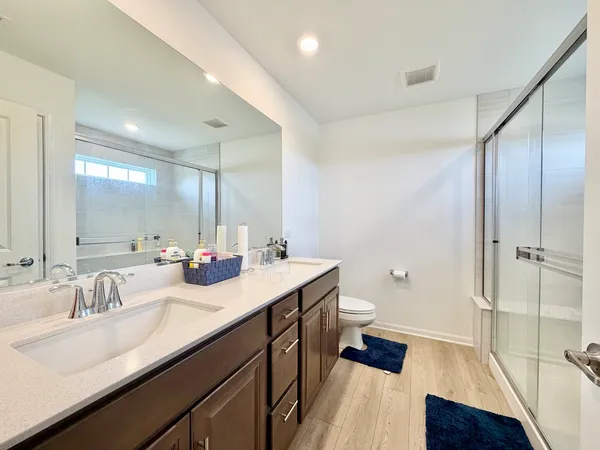 a bathroom with a glass shower door
