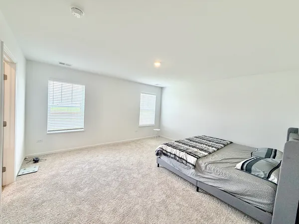 a large white bed in a white room