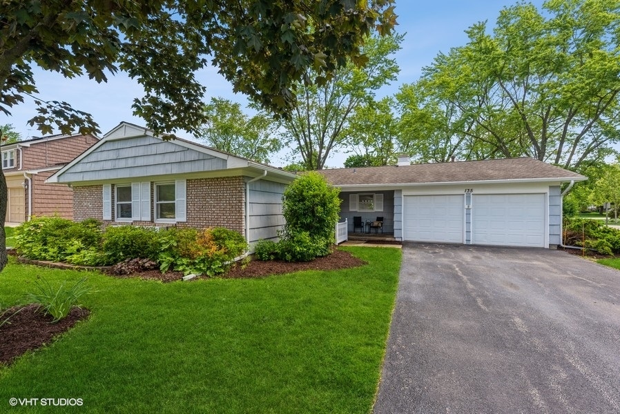 135 Timber Hill Road Buffalo Grove, IL 60089 - Photo 1 of 22 a front view of a house with a garden and yard