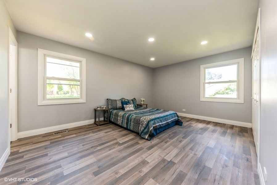 135 Timber Hill Road Buffalo Grove, IL 60089 - Photo 12 of 22 a spacious bedroom with a bed and a window