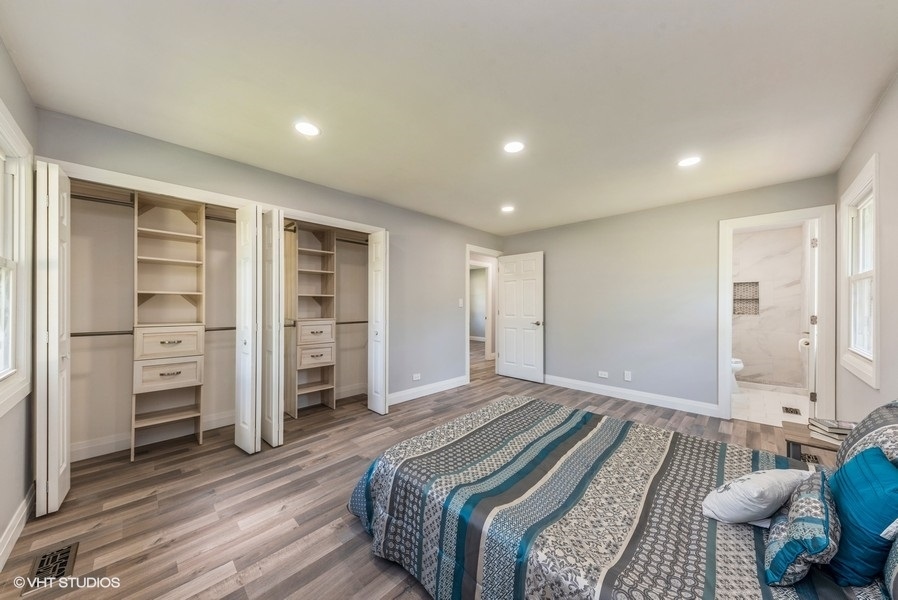 135 Timber Hill Road Buffalo Grove, IL 60089 - Photo 13 of 22 a spacious bedroom with a bed and a walk in closet