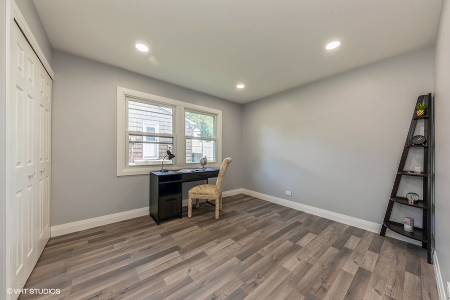 135 Timber Hill Road Buffalo Grove, IL 60089 - Photo 16 of 22 a view of a room with wooden floor and furniture