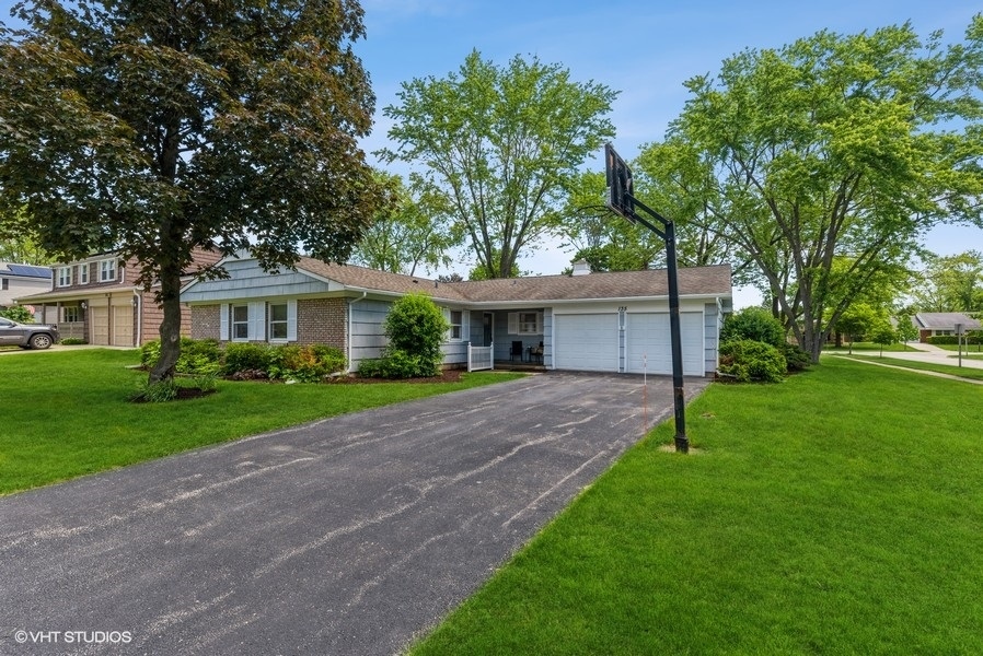 135 Timber Hill Road Buffalo Grove, IL 60089 - Photo 22 of 22 a front view of a house with a yard and an trees