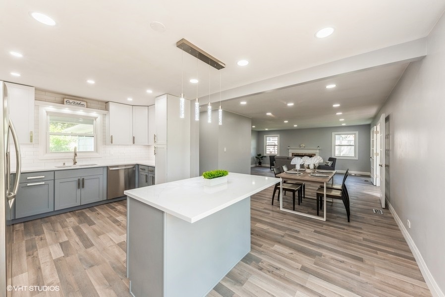 135 Timber Hill Road Buffalo Grove, IL 60089 - Photo 8 of 22 a large kitchen with kitchen island a sink table and chairs