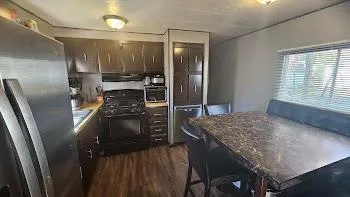 a kitchen with a refrigerator and a stove