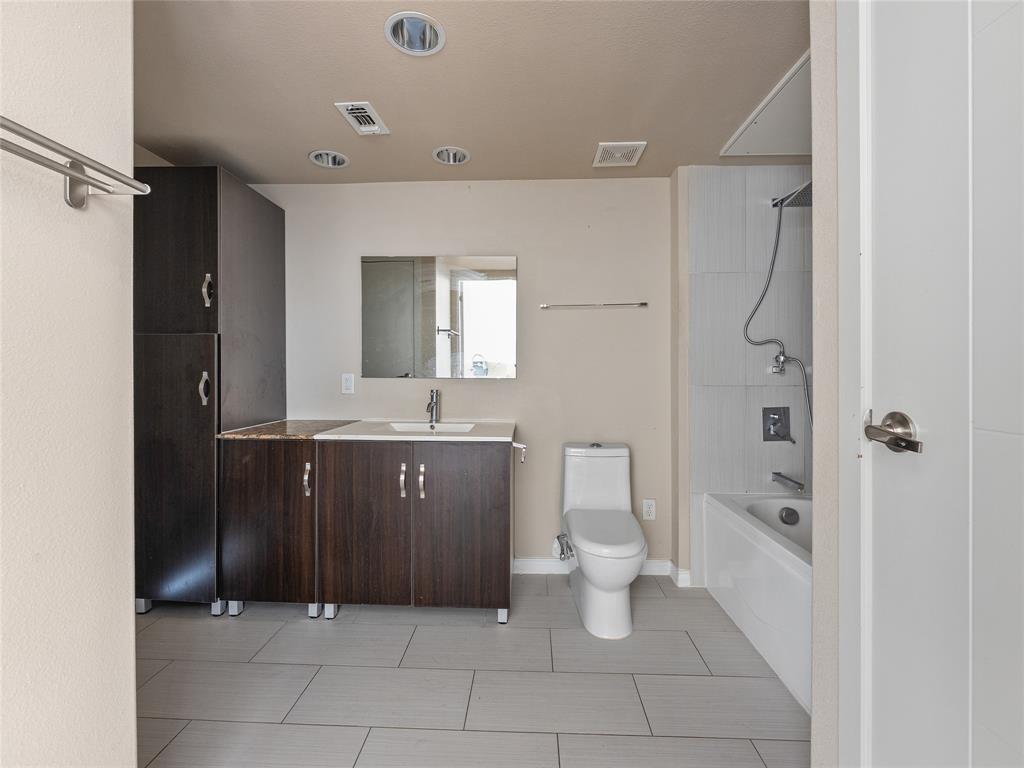 1100 West Trinity Mills Road, Unit 3032 Carrollton, TX 75006 - Photo 14 of 31 a bathroom with a sink a toilet and shower