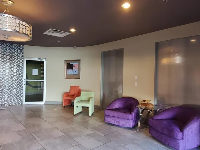 a living room with furniture window and a flat screen tv