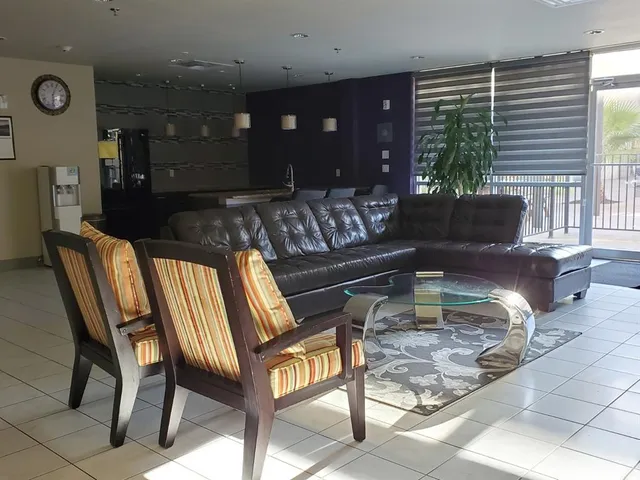 a living room with furniture and a large window