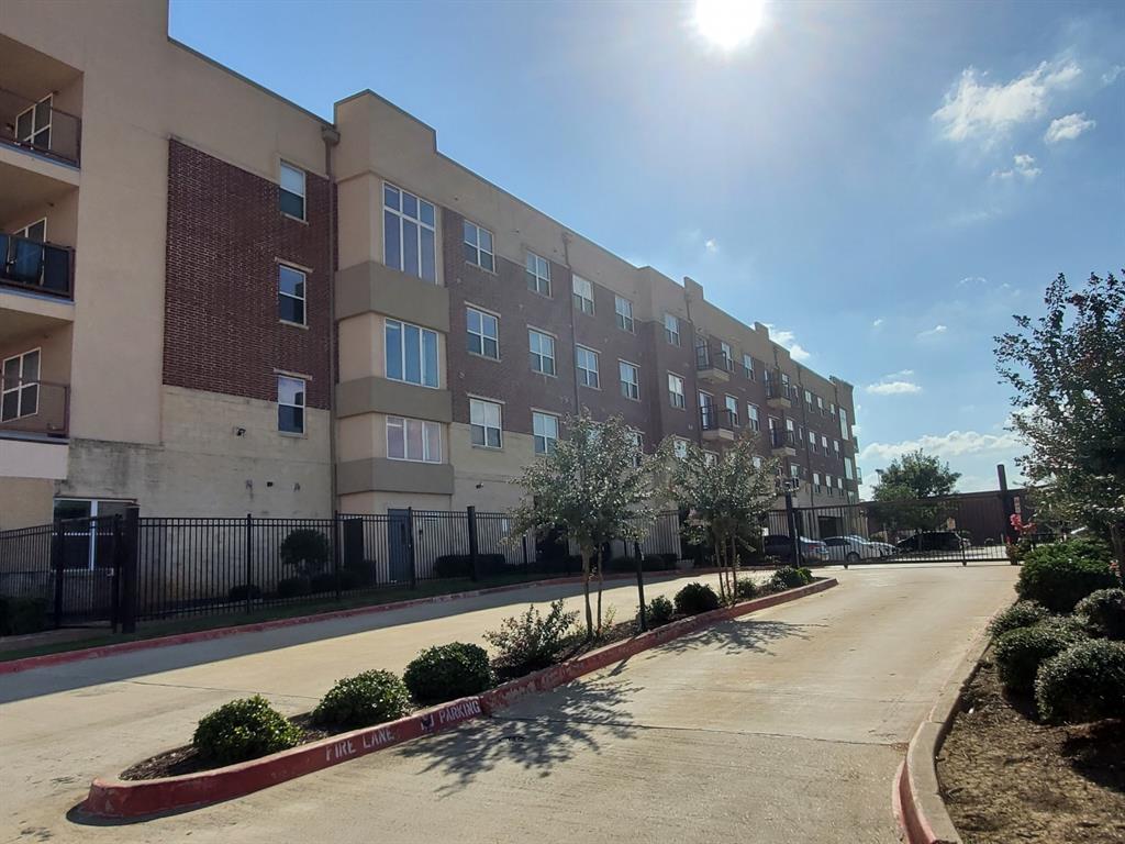 1100 West Trinity Mills Road, Unit 3032 Carrollton, TX 75006 - Photo 26 of 31 a view of a building with a yard