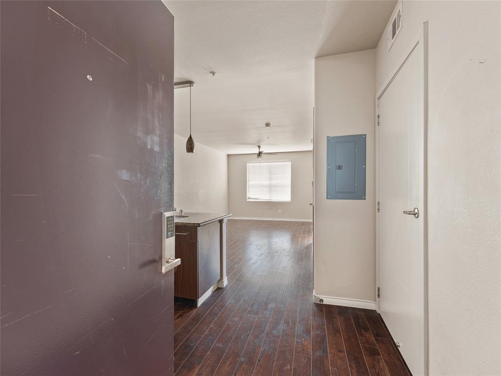 1100 West Trinity Mills Road, Unit 3032 Carrollton, TX 75006 - Photo 3 of 31 wooden floor in an empty room with a window