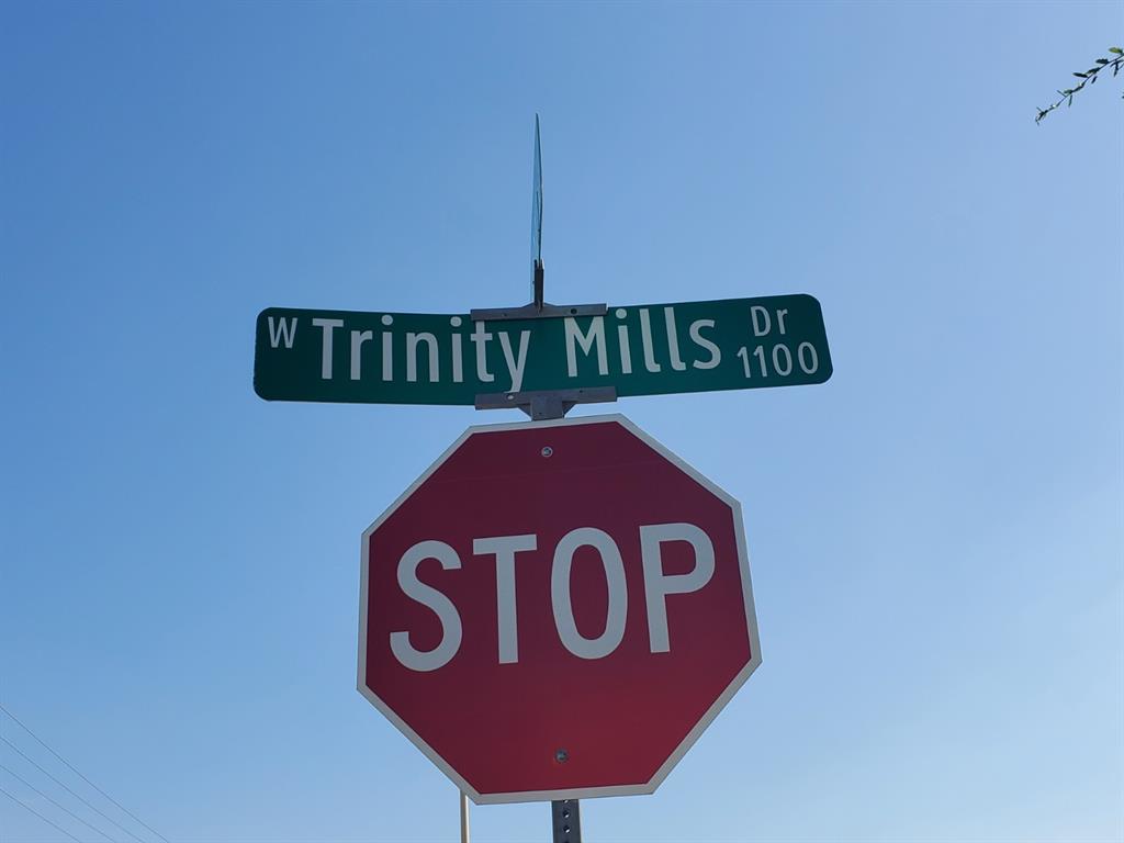 1100 West Trinity Mills Road, Unit 3032 Carrollton, TX 75006 - Photo 4 of 31 a close up of a street sign