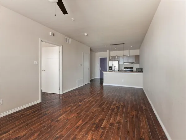 a view of a kitchen with a sink and wooden floor
