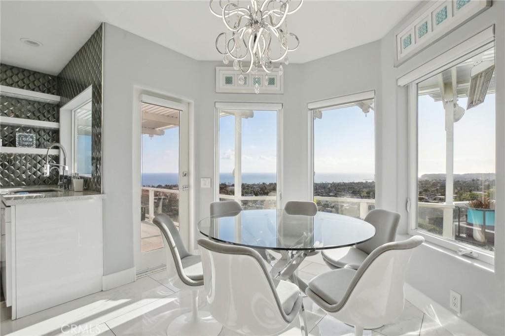3 Via Pasa San Clemente, CA 92673 - Photo 17 of 55 a dining room with chandelier glass table and chairs
