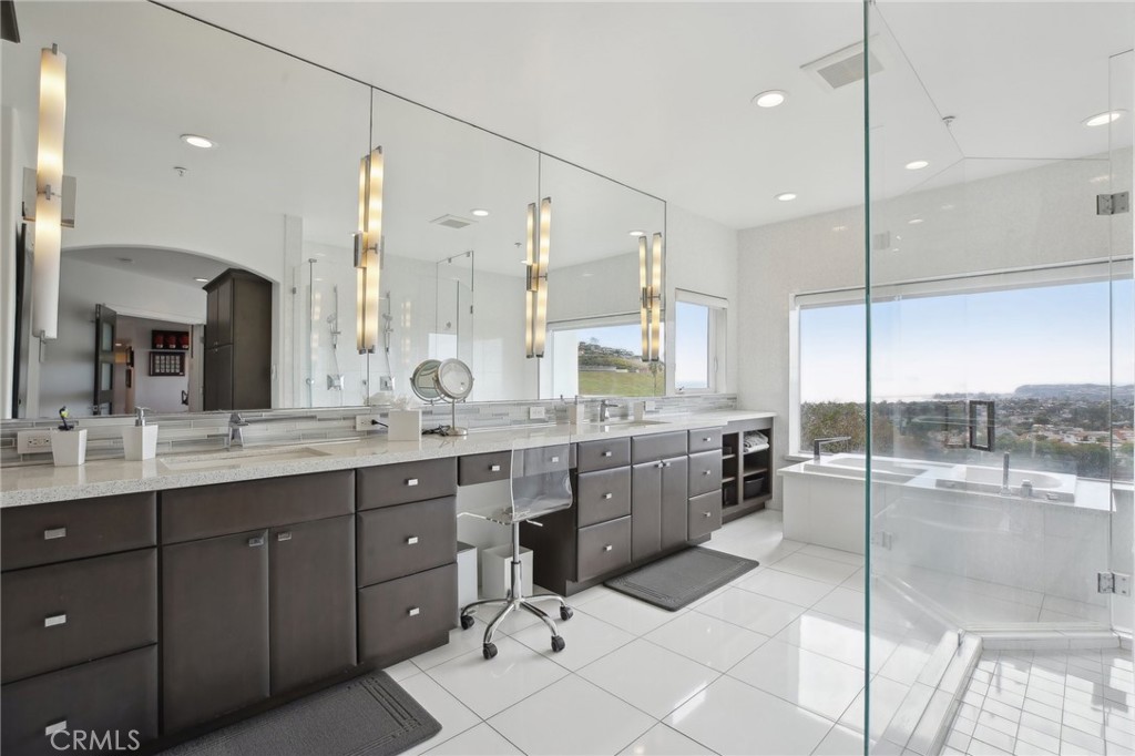 3 Via Pasa San Clemente, CA 92673 - Photo 27 of 55 a large kitchen with a large counter top a sink a counter space and living room view
