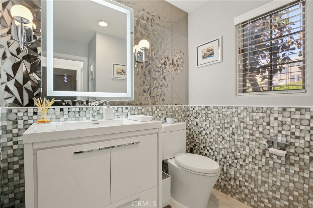 3 Via Pasa San Clemente, CA 92673 - Photo 44 of 55 a bathroom with a granite countertop toilet sink and mirror