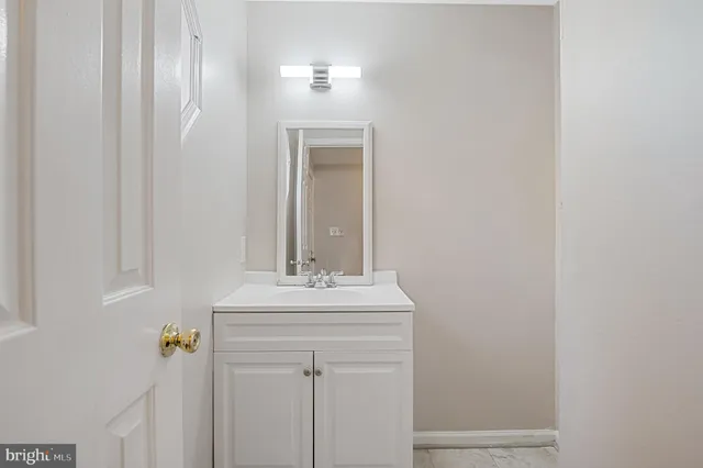 a bathroom with a sink vanity and mirror